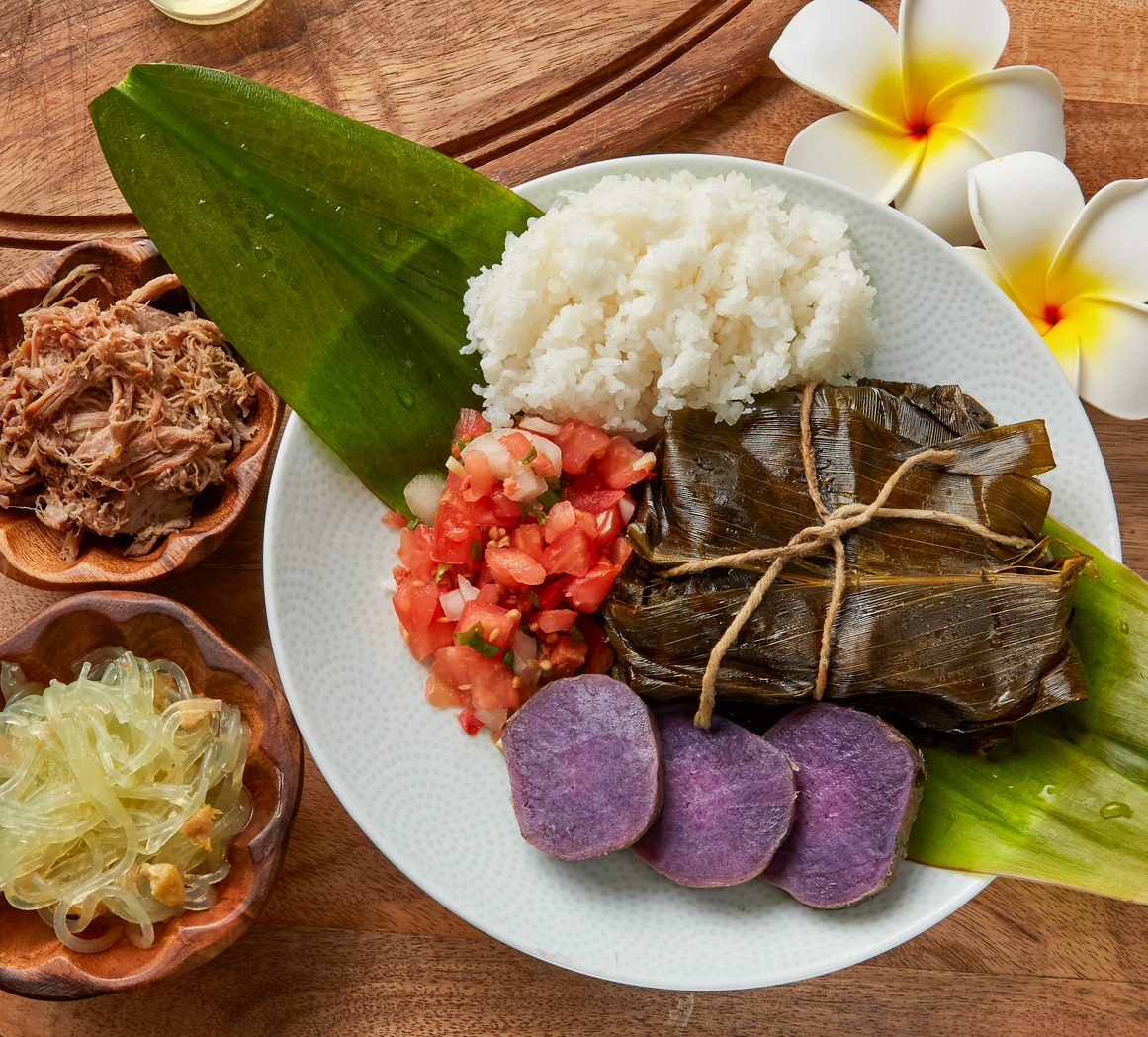 Traditional Hawaiian lau lau plate with kalua pig and lomi salmon